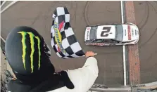  ?? MICHAEL REAVES/GETTY IMAGES ?? Brad Keselowski crosses the finish line first at IMS, a week after winning at Darlington Raceway.