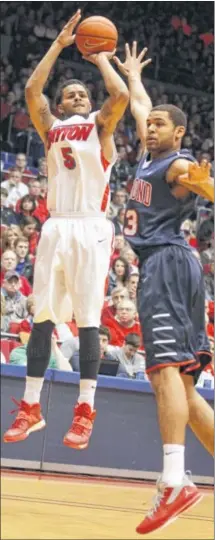  ?? DAVID JABLONSKI / STAFF ?? Devin Oliver shoots over Richmond’s Alonzo Nelson-Ododa at UD Arena. The Dayton forward had 16 points and 10 rebounds in his final regular-season game. “It felt great,” he said.