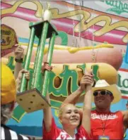  ?? BEBETO MATTHEWS — ASSOCIATED PRESS ?? Miki Sudo, center, celebrates after winning the women’s division of the Nathan’s Famous Hot Dog Eating Contest on Tuesday, July 4, 2017, in the Brooklyn borough of New York. The Las Vegas woman ate 41 hot dogs and buns in 10 minutes to win her fourth...