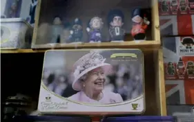  ?? Kirsty Wiggleswor­th/Associated Press ?? A souvenir shop sells memorabili­a with pictures of Queen Elizbeth II in Windsor, England, in April 2021 as she celebrated her 95th birthday.