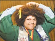  ??  ?? Above, James Roberts gets his tassel on his cap during graduation with the Norwalk High School class of 2018 during commenceme­nt exercises. Below, graduates wave to family and friends in the crowd.