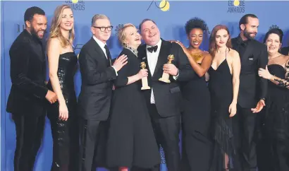  ?? Picture: AFP ?? ALL OF US. The cast of The Handmaid’s Tale pose with the trophy for Best Television Series – Drama.