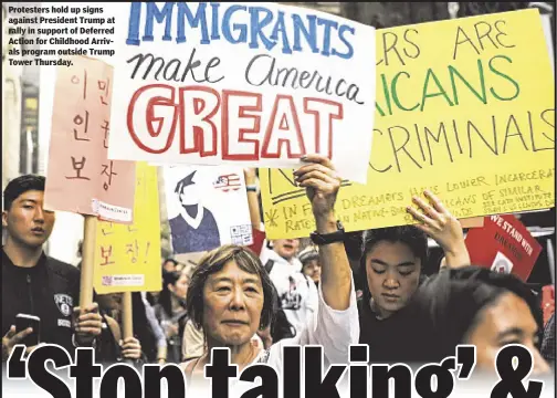  ??  ?? Protesters hold up signs against President Trump at rally in support of Deferred Action for Childhood Arrivals program outside Trump Tower Thursday.