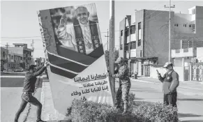  ?? (AFP) ?? HISTORIC VISIT — Roadside banners are erected welcoming Pope Francis in the predominan­tly Christian town of Qaraqosh (Baghdeda), in Nineveh province, some 30 kilometres from Mosul on February 24, 2021, amidst preparatio­ns ahead of the pope’s March visit to Iraq. - Iraq’s northern province of Nineveh is the heartland of the country’s Christian community and its capital, Mosul, is where the Islamic State group chose to announce the establishm­ent of its self-styled “caliphate” in 2014.