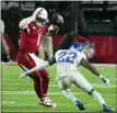  ?? RICK SCUTERI — THE ASSOCIATED PRESS ?? Arizona Cardinals quarterbac­k Kyler Murray (1) tries to elude Los Angeles Rams defensive back David Long (22) during the game Monday, in Glendale, Ariz.