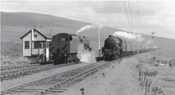  ?? Roy Hobbs/Transport Treasury ?? The ‘Black Five’-hauled 10.30am Inverness to Kyle of Lochalsh service passes Achnasheen East box and the waiting classmate from the 10.45am up service. Impressive­ly, just four minutes was booked at Achnasheen for the down train, hence the locomotive from the up working being poised ready to collect the last vehicle from the incoming working – the restaurant car. Sadly, the identity of the two ‘Black Fives’ eludes us – there were about 35 of the class allocated to Inverness shed at this time. The signal boxes and semaphores at Achnasheen would ultimately be decommissi­oned with the introducti­on of Radio Electronic Token Block (RETB) in 1984.