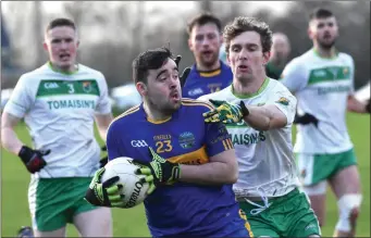  ??  ?? Cathal Kennelly, St. Senans, breaking past Thomas Kenneally, Ballydonog­hue, in the North Kerry final