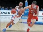  ?? THE ASSOCIATED PRESS FILE ?? Tony Parker drives past Cedi Osman during a EuroBasket European Basketball Championsh­ip match at Pierre Mauroy stadium in Lille, northern France, in 2015.