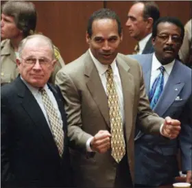  ?? AP FILE PHOTOS ?? Above: O.J. Simpson reacts on Oct. 3, 1995, as he is found not guilty of murdering his exwife, Nicole Brown Simpson, and her friend Ron Goldman. At left is defense lawyer F. Lee Bailey; at right is defense attlawyero­rney Johnnie Cochran Jr. Below:...