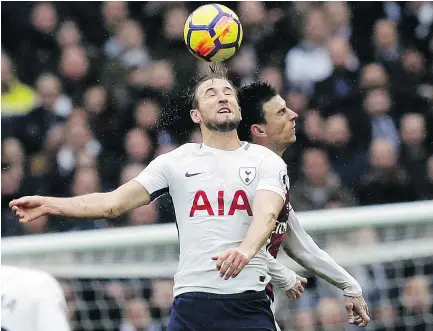  ?? — THE ASSOCIATED PRESS ?? Tottenham’s Harry Kane, front, and Arsenal’s Laurent Koscielny battle for the ball during Saturday’s match between Tottenham Hotspur and Arsenal at Wembley Stadium.