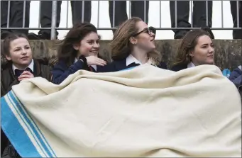  ??  ?? Sligo Grammar School students keeping warm during the rugby game.