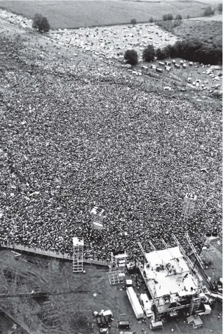  ?? AP ?? In this August 16, 1969, file photo, thousands of rock music fans are packed around the stage in a field near Bethel, New York, at the Woodstock Festival.