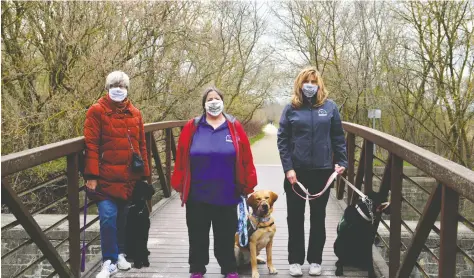  ?? Sean Heeger ?? Sandra James, Deb Cserhalmi, and Cheryl Bauman of the Floradale Friend of Dog Guides Lions Branch Club are taking a walk to raise funds for Dog Guides Canada along with Flossy, Portia and Bindi.