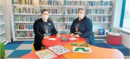  ?? Photo / Ilona Hanne ?? Librarians Kate Fairhurst and Bridget Roper enjoy a game of Ta¯ karo at the whare pukapuka.