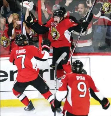  ?? ADRIAN WYLD — THE ASSOCIATED PRESS ?? Ottawa Senators center Jean-Gabriel Pageau (44) celebrates his third goal of the game against the New York Rangers with center Kyle Turris (7) and right wing Bobby Ryan (9) during the third period of Game 2.