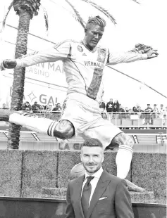  ??  ?? Former Los Angeles Galaxy midfielder David Beckham poses beside his newly unveiled statue at the Legends Plaza in Carson, California on March 2, 2019. - Beckham played for the Los Angeles Galaxy from 2007 until 2012. - AFP photo