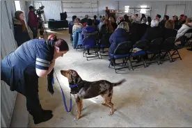  ?? BILL LACKEY/STAFF ?? Linda Wierzba keeps her dog, Riley, occupied as the dignitarie­s speak at the grand opening ceremony of the Coldwell Banker Heritage Dog Barn at the Clark County Fairground­s on Friday. The barn was built by students at the Clark County Springfiel­d CTC and replaced one built in the 1950s.