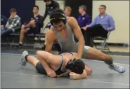  ??  ?? Pottstown’s Demond Thompson, top, controls Phoenixvil­le’s Jake Geiger at Pottstown. Thompson won by first period pin.