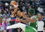  ?? CARLOS OSORIO — THE ASSOCIATED PRESS ?? Detroit Pistons guard Jaden Ivey (23) looks to pass as Boston Celtics guard Marcus Smart (36) defends during the second half of an NBA basketball game, Saturday in Detroit.