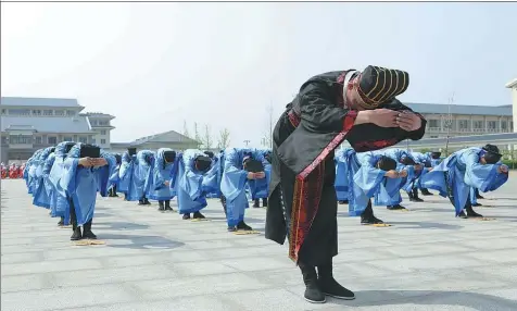  ?? PROVIDED TO CHINA DAILY ?? Convicts at Changtai Prison in Tianjin recite poetry at the opening ceremony of the annual Inmates’ Sports Festival. The prison has launched a training center to teach long-term inmates about the modern world to help ease their transition when they are...