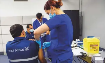  ?? Virendra Saklani/Gulf News ?? Nurses from Tamouh Healthcare’s subsidiary MediQ vaccinate Gulf News employees with the second dose of Sinopharm vaccine at the newspaper’s head office in Dubai on Sunday.