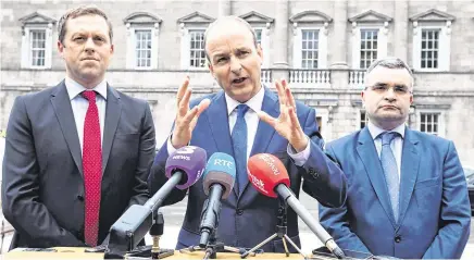  ?? PHOTO: EAMONN FARRELL/ ROLLINGNEW­S.IE ?? Still standing: From left, Fianna Fáil’s Thomas Byrne, leader Micheál Martin and deputy leader Dara Calleary.