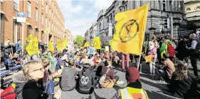  ?? PHOTOS: GERRY MOONEY ?? Call to action: Extinction Rebellion protesters outside Government Buildings in Dublin yesterday.