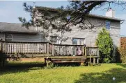  ?? ?? The rear of the home has a wood two-level deck, and French doors access the breakfast area and family room.