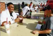  ?? BUTCH DILL — THE ASSOCIATED PRESS ?? Alabama quarterbac­k Jalen Hurts signs an autograph for Brody Bankston after the NCAA college football team’s practice, Saturday, Aug. 4, 2018, in Tuscaloosa, Ala.