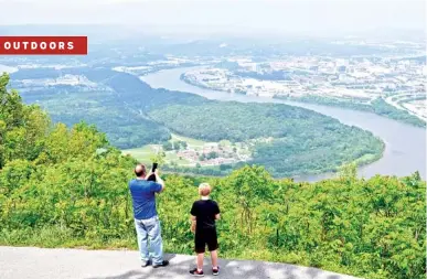  ?? STAFF PHOTO BY MARK PACE ?? Chris and James Ogren, from left, look out over Moccasin Bend and Chattanoog­a from Point Park on Lookout Mountain.
