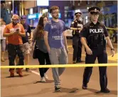 ?? — AP ?? Civilians are escorted from the scene of the shooting in Toronto on Sunday.