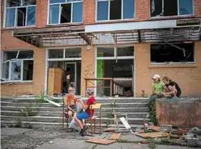  ?? — ap ?? Children play outside their Chernihiv School no. 21 in Ukraine, which was bombed by russian forces.