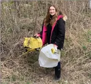  ?? COURTESY PHOTO ?? Eighth-grader Andrea Cox, creator of “Ditch” the Trash Day, picks up trash near her home in Armada Township.