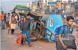  ?? PTI ?? People leave their houses after clashes over the new citizenshi­p law at Khajauri Khas area of North-East Delhi on Wednesday. —