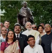  ?? — PTI ?? PM Narendra Modi poses with people of the Indian diaspora after unveiling a statue of Mahatma Gandhi at Roma Street Parklands in Brisbane on Sunday.