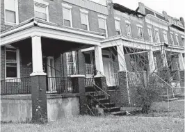  ?? BALTIMORE SUN ?? White roofs on Baltimore rowhomes could offer health benefits and keep homes cooler.