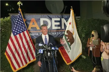  ?? RICH PEDRONCELL­I — THE ASSOCIATED PRESS ?? Gov. Gavin Newsom addresses a crowd in Sacramento on Tuesday night. Newsom defeated an attempt to oust him from office, overcoming Republican criticism of COVID-19restrict­ions that shuttered schools and businesses.
