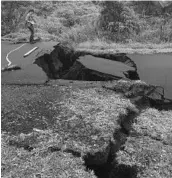  ?? U.S. GEOLOGICAL SURVEY ?? In a Thursday image, a geologist monitors the damage in Pahoa, Hawaii. Cracks caused by the underlying intrusion of magma expanded significan­tly in the past 24 hours.