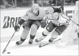  ?? Mark Humphrey Associated Press ?? THE PREDATORS’ Roman Josi, left, keeps the puck away from the Kings’ Jeff Carter during the first period. The Kings lost their sixth consecutiv­e game.