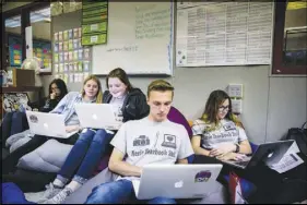  ??  ?? Marjory Stoneman Douglas yearbook staffers work on the Aerie. The 452-page book is scheduled to be published in May and distribute­d to more than 2,500 people.