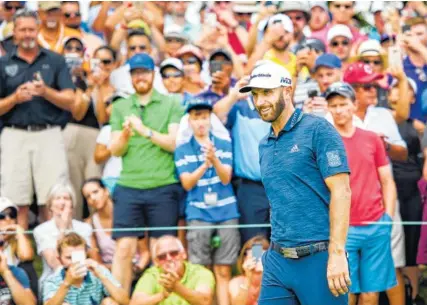  ?? THE ASSOCIATED PRESS ?? Dustin Johnson smiles as he walks onto the first hole during the final round of the Canadian Open on Sunday at the Glen Abbey Golf Club in Oakville, Ontario. Johnson shot a 66 in the final round to win the tournament by three strokes.