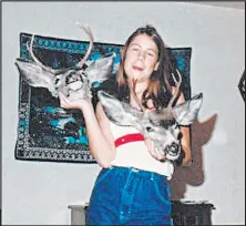  ?? John Isaacson ?? This undated photo shows Stephanie Isaacson posing with deer heads. Stephanie and her father, John, would often go hunting together.