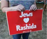  ?? —AFP ?? DETROIT: People hold signs in support of US Democratic Representa­tive for Michigan’s 13th congressio­nal district Rashida Tlaib during ‘Shabbat in the Park With Rashida’ event with pro BDS (Boycott, Divestment and Sanctions) group in Pallister Park in Detroit, Michigan.