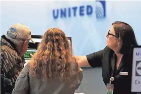  ?? ASSOCIATED PRESS ?? A United Airlines service desk employee helps travelers at Denver Internatio­nal Airport. United Airlines said Monday it is adding regional jet service between Appleton and Denver and Madison and San Francisco.