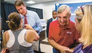  ?? KENDALL WARNER/STAFF ?? Gov. Glenn Youngkin and 24th District state Senate candidate Danny Diggs speak with supporters at an early voting rally on Sept. 20.