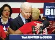  ?? PAUL VERNON — THE ASSOCIATED PRESS ?? Democratic presidenti­al candidate former Vice President Joe Biden hugs Crystal Turner of Columbus, Ohio, with Moms Demand Action during a campaign rally Tuesday.