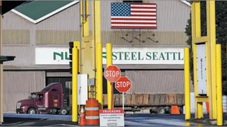  ?? AP PHOTO/ELAINE THOMPSON, FILE ?? In this Feb. 25, 2016 file photo, a truck carries a load at the Nucor Steel plant in Seattle. U.S. companies pursuing exemptions from President Donald Trump’s tariff on imported steel are accusing American steel manufactur­ers of spreading inaccurate...