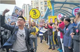  ??  ?? Supporters of pro-democracy candidate Lee Cheuk-yan, left, shout slogans against supporters of establishm­ent candidate Chan Hoi-yan, right, on voting day in Hong Kong yesterday.