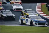  ?? NELL REDMOND — THE ASSOCIATED PRESS ?? Chase Elliott (9) leads the way out of Turn 7 in a NASCAR Cup Series race at Charlotte Motor Speedway in Concord, N.C., on Sunday.
