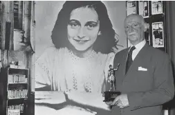  ?? DAVE CAULKIN/THE ASSOCIATED PRESS ?? Dr. Otto Frank in front of a poster of his daughter, Anne, in a 1971 photo.